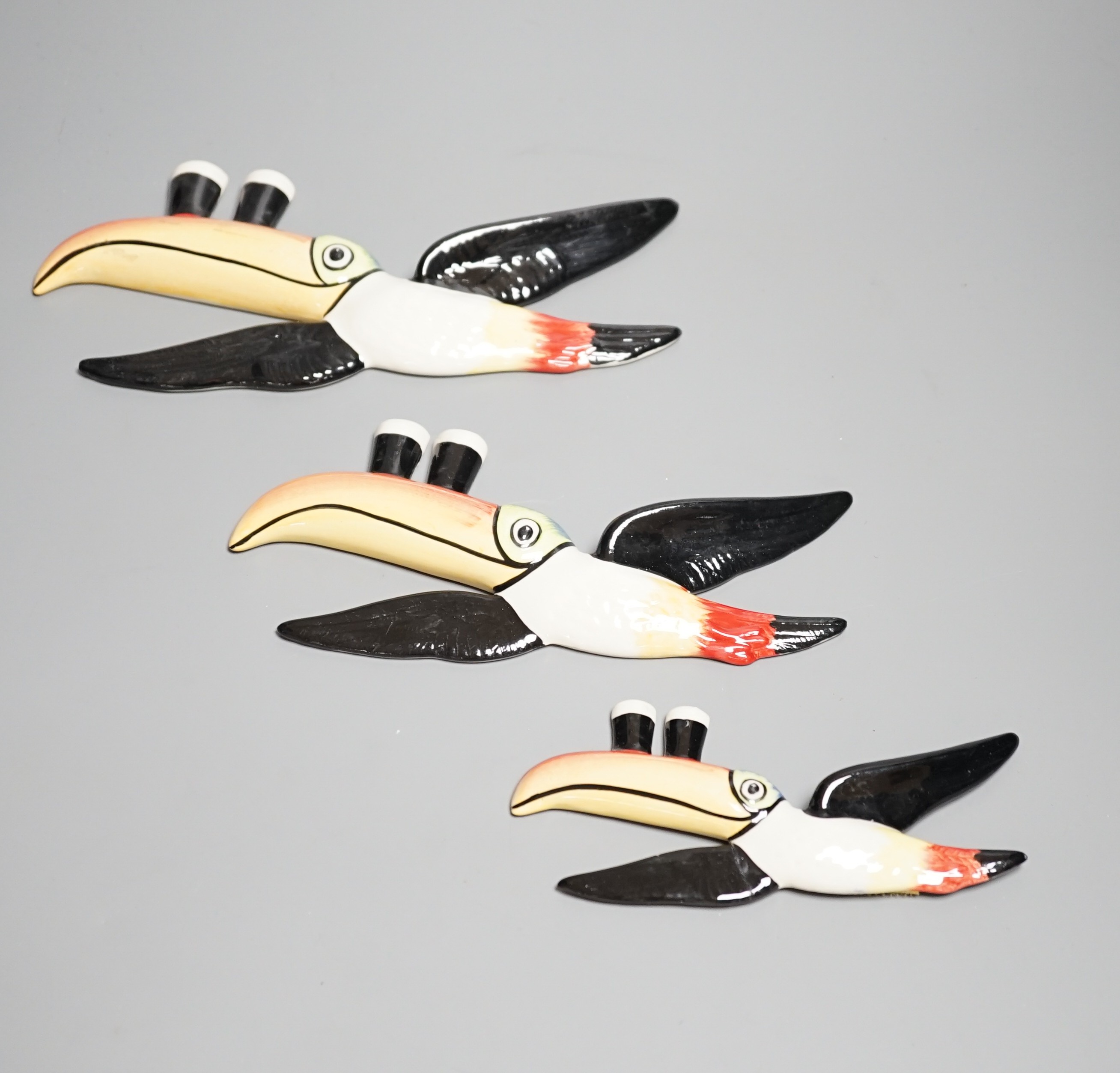 A graduated trio of Guinness toucans, widest 25cm